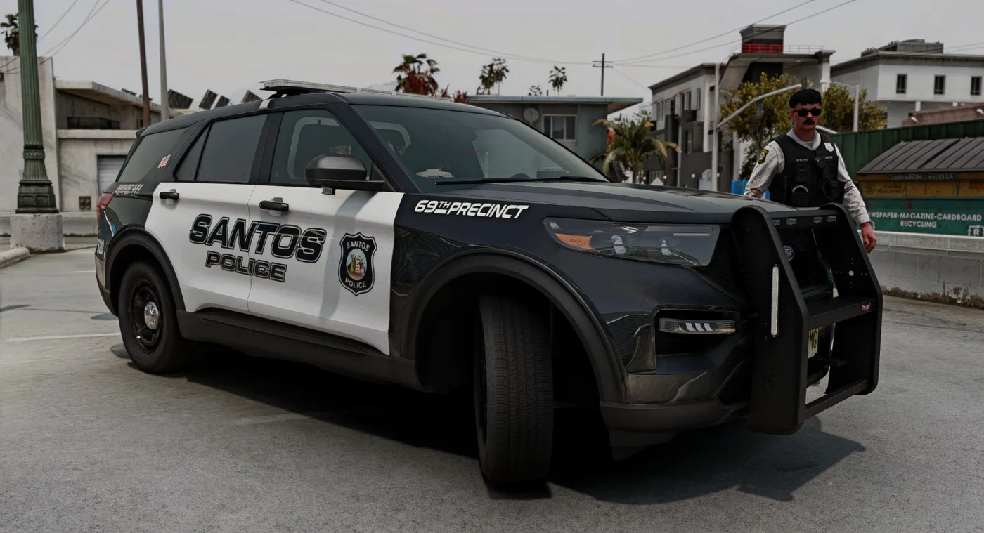 A Santos Police patrol vehicle with an officer beside it